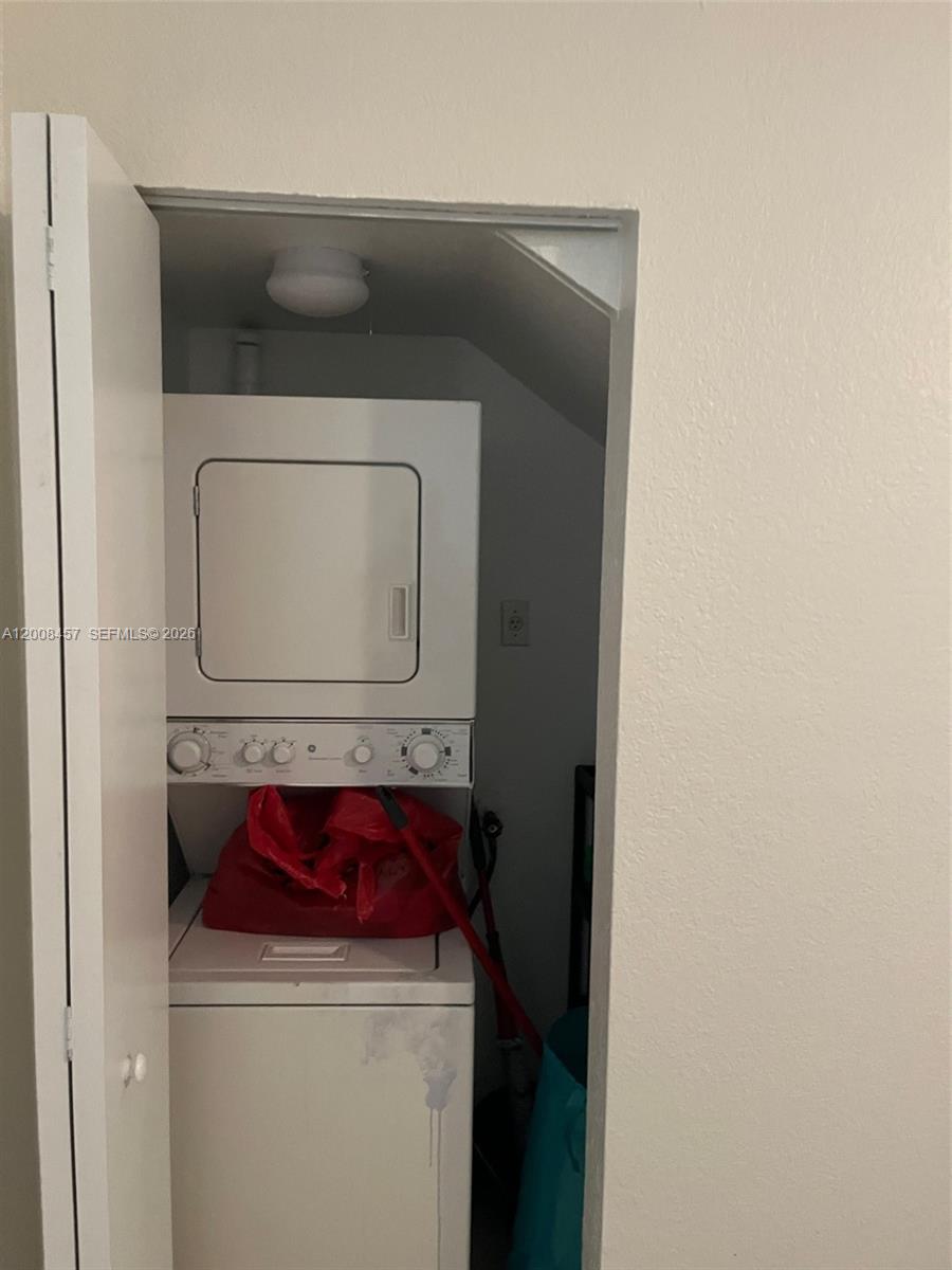 A stacked washer and dryer unit is located inside a small closet — 403 NW 84th St # 403, Miami FL 33150, MIAMI, FL