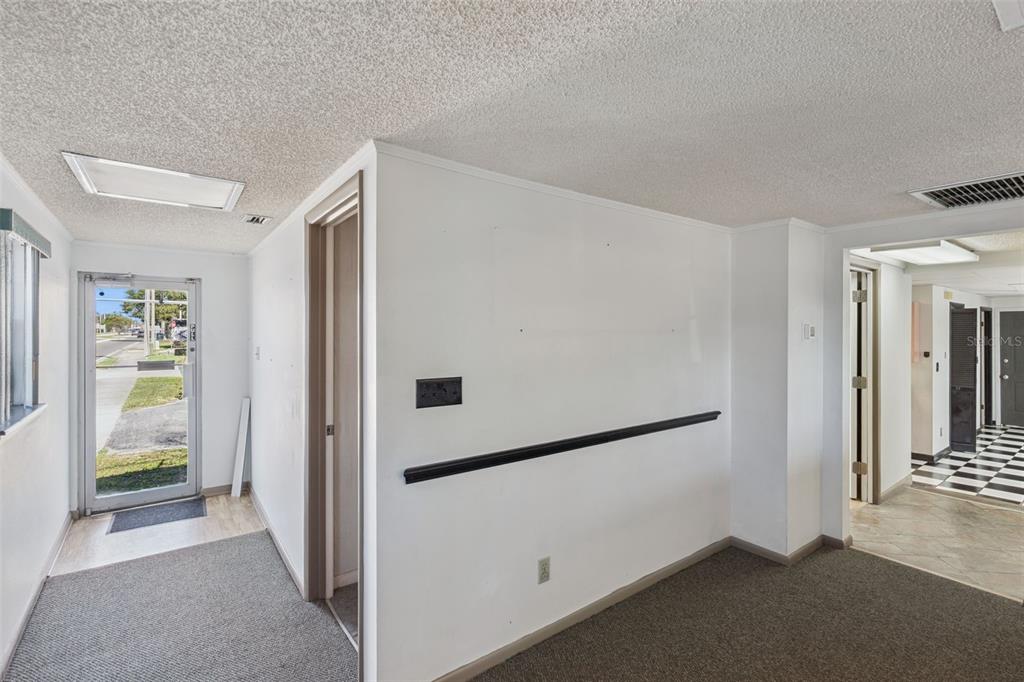 A room with gray carpet, white walls, a black chair rail, and a glass-paneled door — 1610 1ST STREET S, WINTER HAVEN, FL