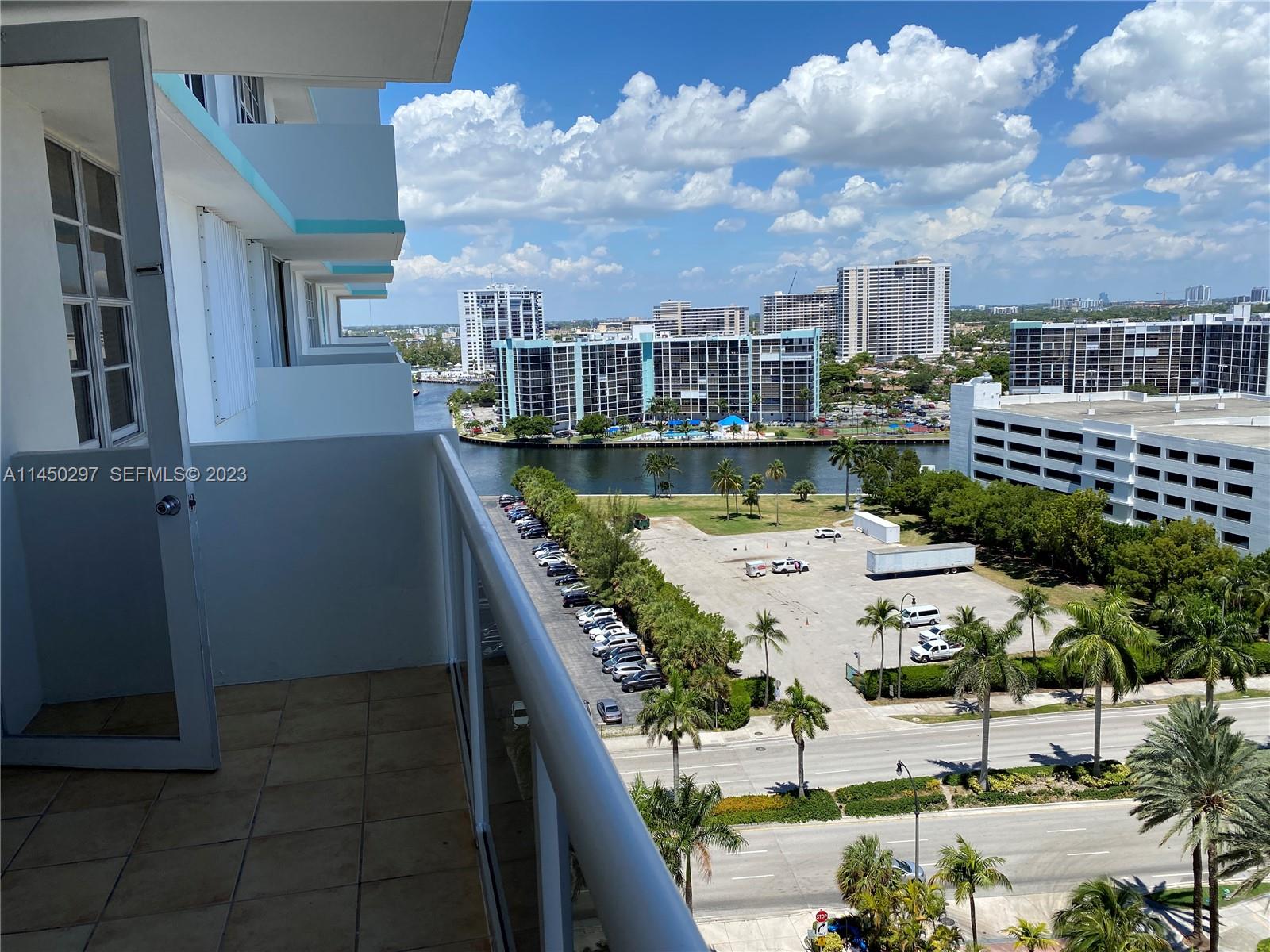 A balcony overlooks a parking lot, a waterway, and several high-rise apartment buildings — 3725 S Ocean Dr # 1521, Hollywood FL 33019, HOLLYWOOD, FL