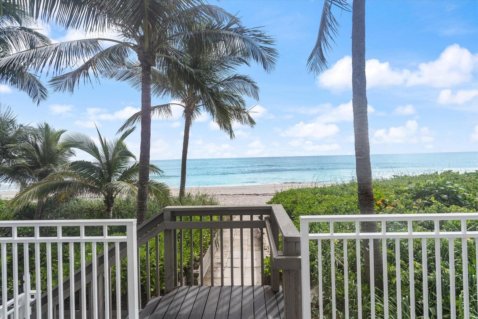 A wooden staircase leads from a balcony through palm trees to a sandy beach — 3215 S Ocean Boulevard # 303, Highland Beach FL 33487, HIGHLAND BEACH, FL