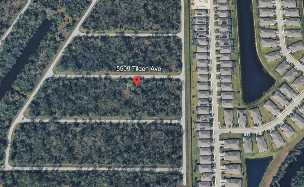 An aerial map view shows a vacant, wooded rectangular lot situated next to a residential neighborhood — 15509 TILDEN AVENUE, PORT CHARLOTTE, FL
