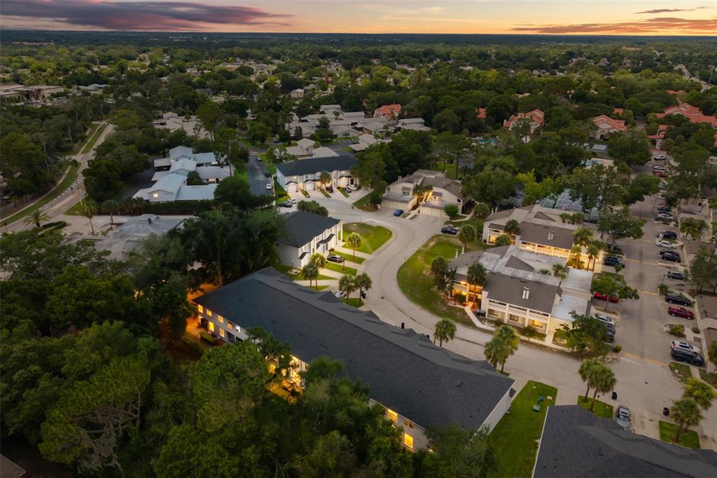 An aerial view shows multiple multi-story residential buildings surrounded by trees and parking lots — 520 MAJESTIC WAY, ALTAMONTE SPRINGS, FL
