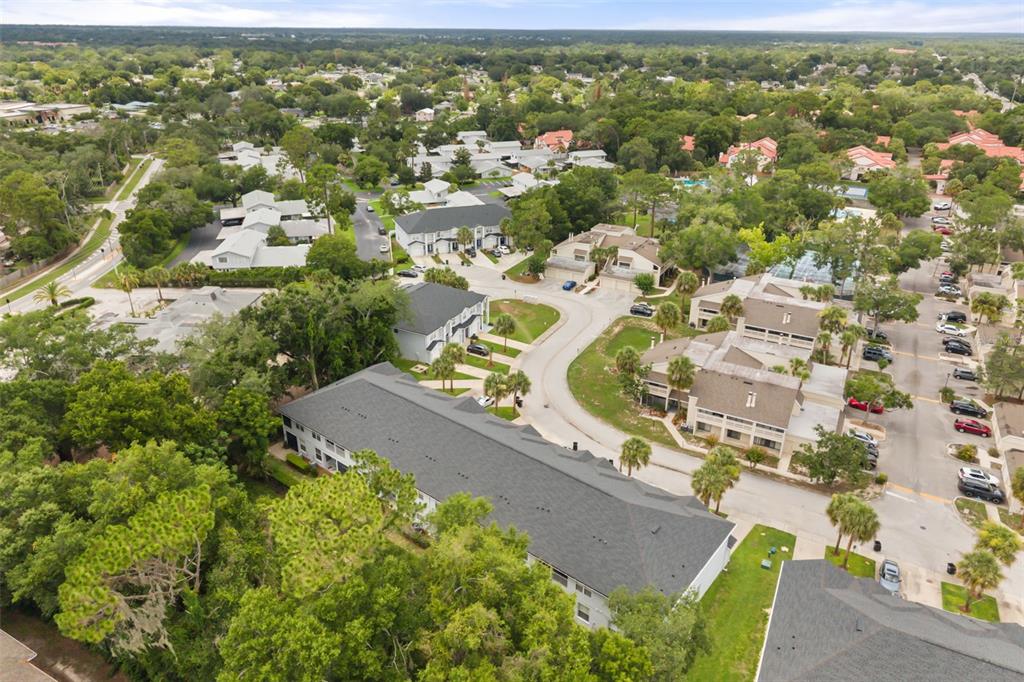 An aerial view shows a residential apartment complex with multiple buildings, parking lots, and trees — 520 MAJESTIC WAY, ALTAMONTE SPRINGS, FL