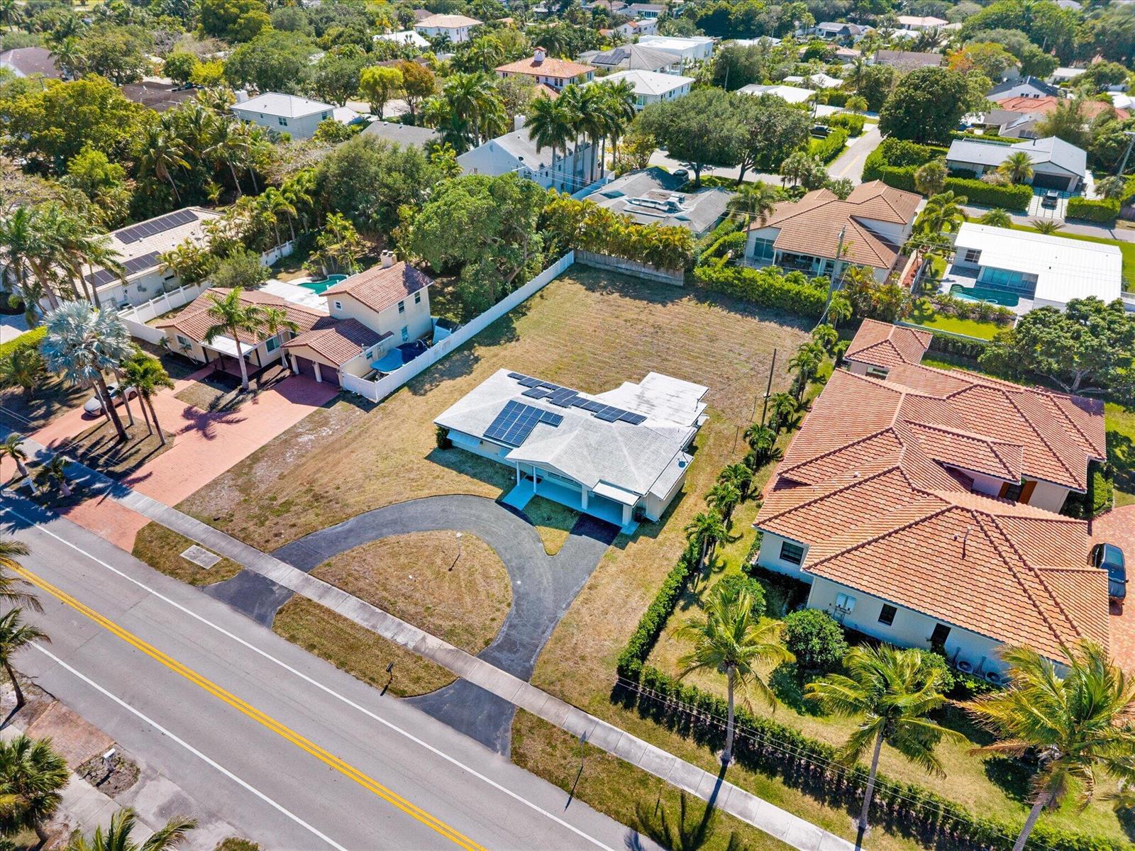 An aerial view shows a single-story house with solar panels and a circular driveway — 1035 NW 4th Avenue, Boca Raton FL 33432, BOCA RATON, FL