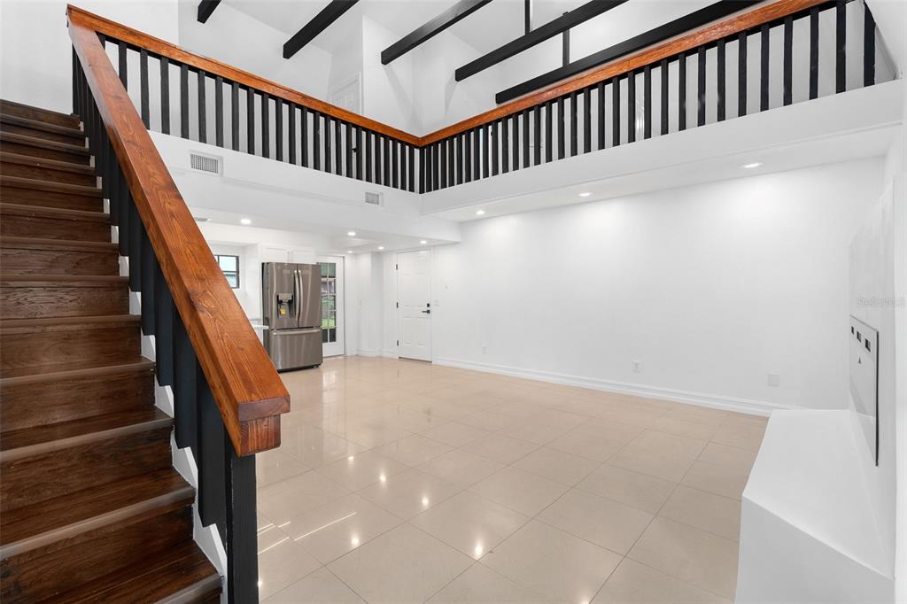 A two-story house with a white exterior, black roof, and a two-car garage at dusk — 4221 GREENFERN DRIVE, ORLANDO, FL