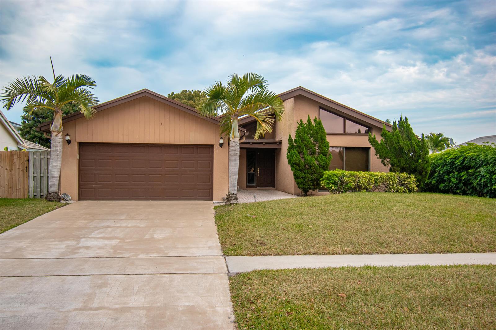 A single-story house with a brown garage, palm trees, and a concrete driveway — 21566 Arbor Way, Boca Raton FL 33433, BOCA RATON, FL