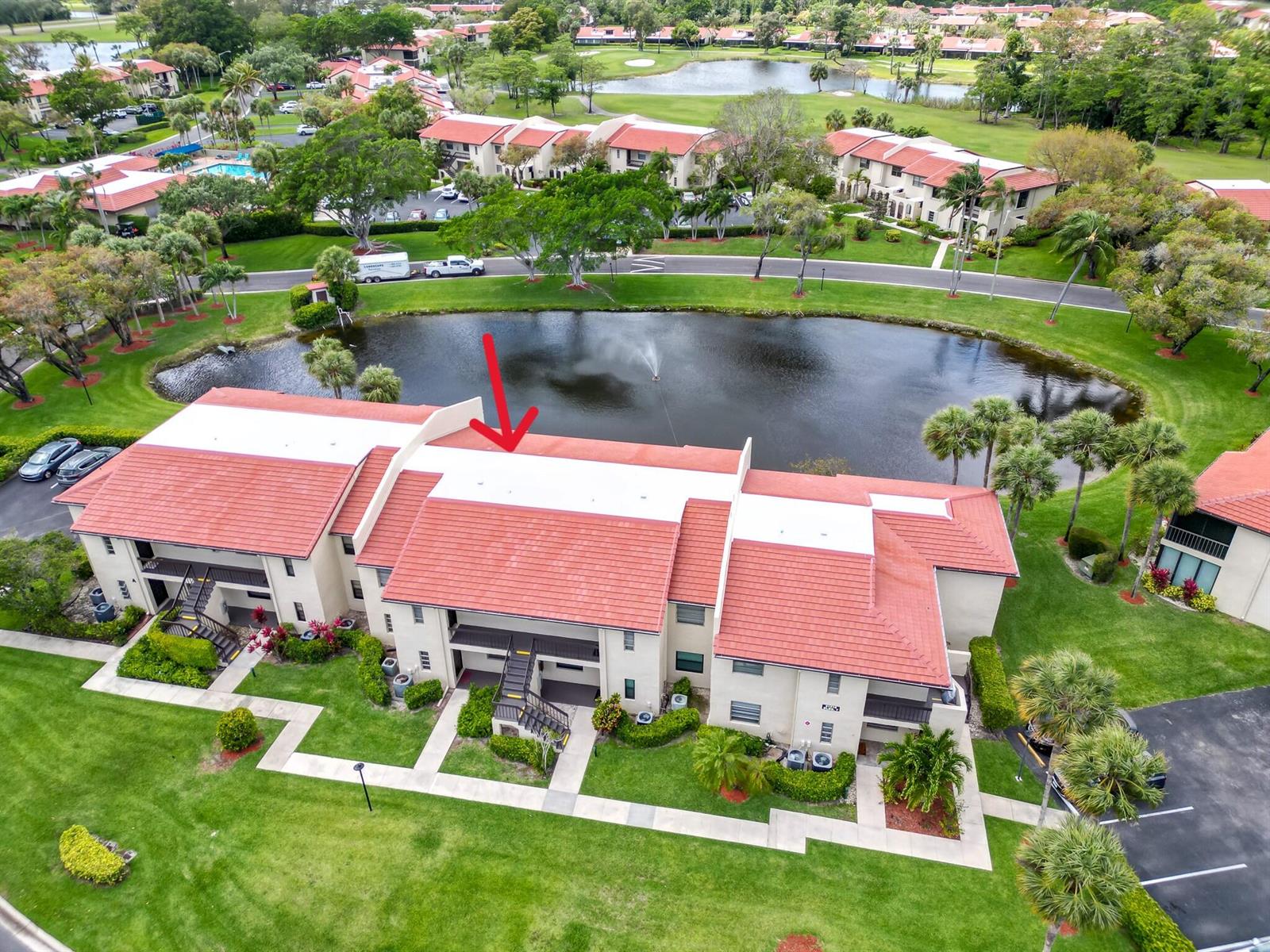 An aerial view shows a multi-story apartment building with a red tile roof — 21218 Lago Circle # F, Boca Raton FL 33433, BOCA RATON, FL