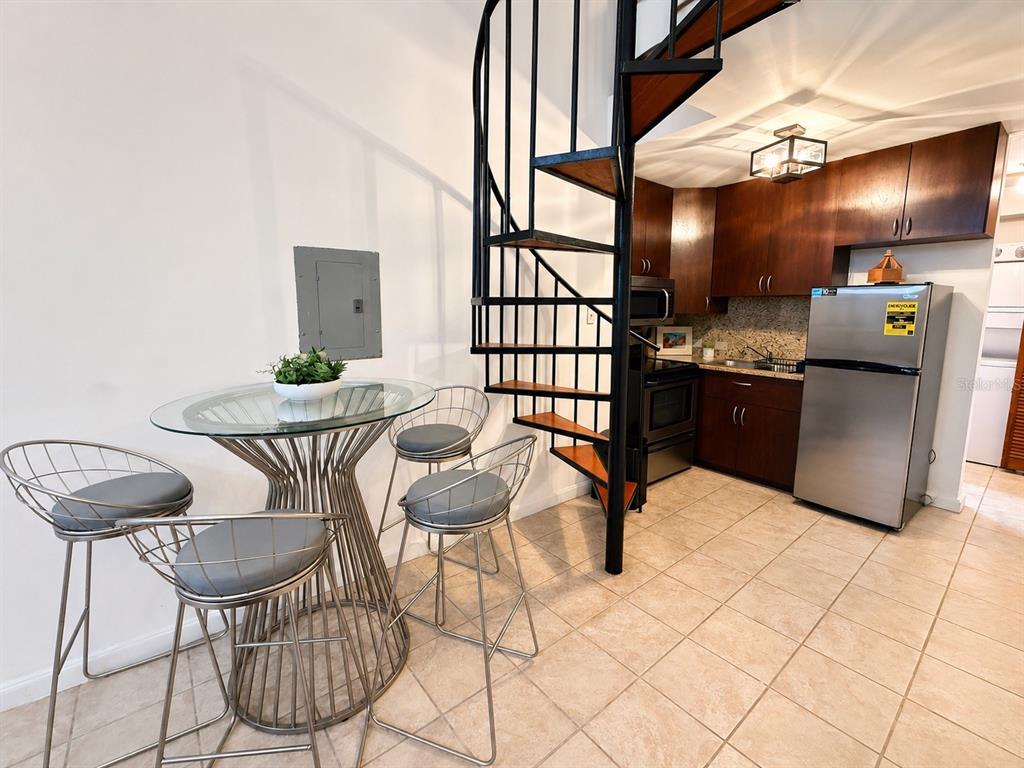 A bathroom features a white vanity, a toilet, and a tiled walk-in shower with curtains — 315 Tetuan Street GAMBARO UNIT 1-B, SAN JUAN, PR
