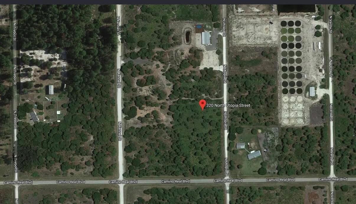 This is a satellite map view of a wooded lot with nearby residential streets — 320 N Utopia Street, Clewiston FL 33440, CLEWISTON, FL