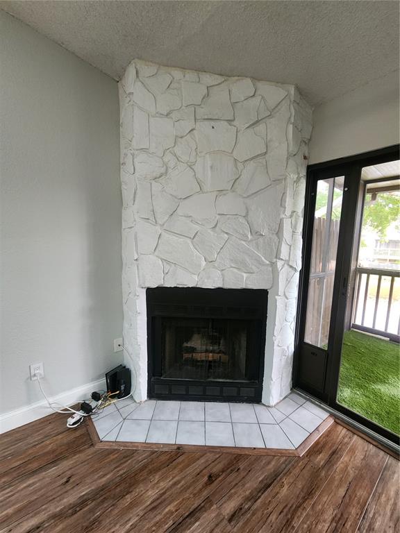 A corner fireplace with white stone facing and a tiled hearth in a living room — 6236 93RD TERRACE N UNIT 3504, PINELLAS PARK, FL