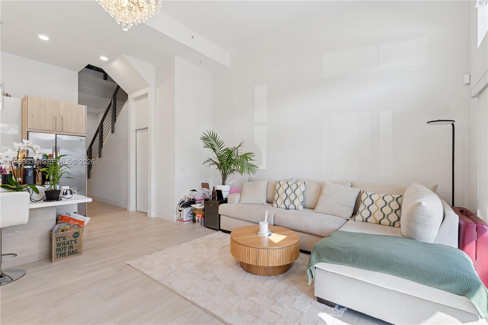 A living room features a sectional sofa, a round coffee table, and an adjacent kitchen — 4440 NW 8th Ct, Plantation FL 33317, PLANTATION, FL