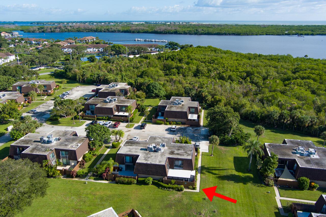 An aerial view of a multi-unit residential complex with a red arrow pointing toward a patio — 6197 SE Riverboat Drive # 1008, Stuart FL 34997, STUART, FL