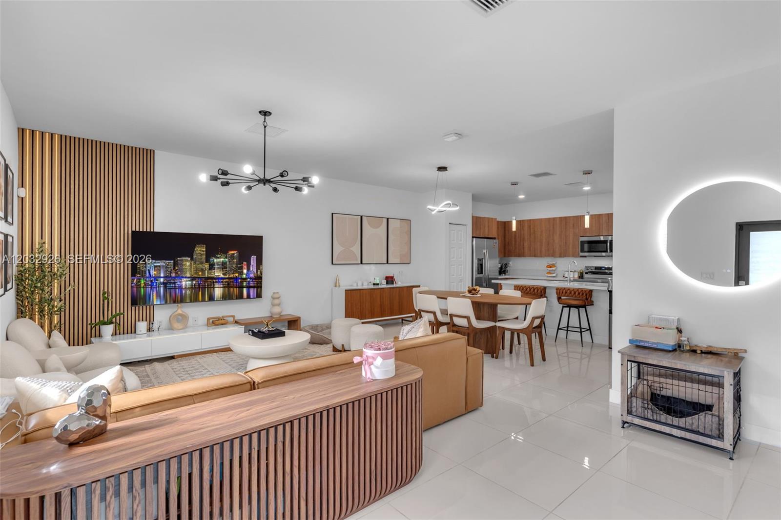 An open-concept living and dining area features wood-slat accents, a modern kitchen, and tile flooring — 4963 NW 83rd Path # 4963, Doral FL 33166, DORAL, FL