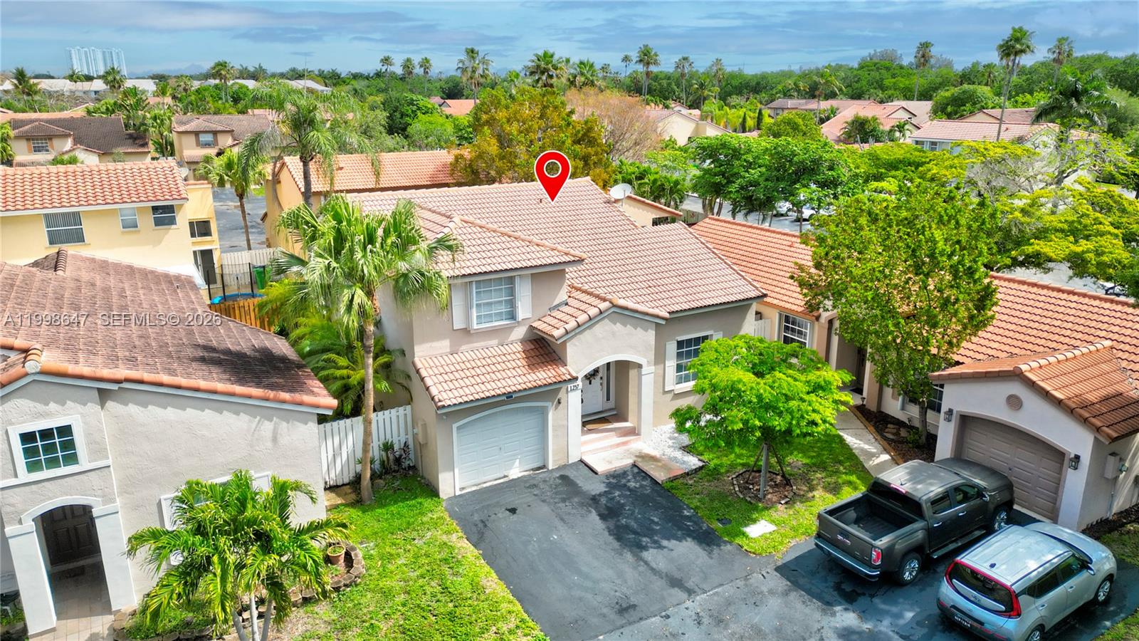 An aerial view shows a two-story suburban house with a tiled roof and driveway — 1237 NW 125th Ter, Sunrise FL 33323, SUNRISE, FL