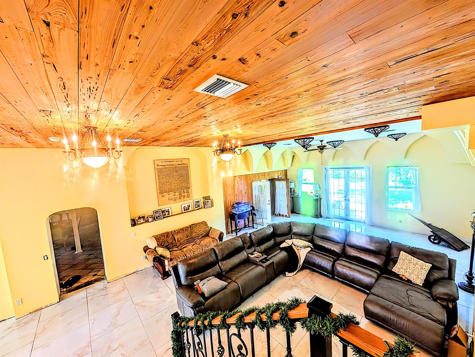 A large living room features a wood-plank ceiling, tile floors, and a dark leather sectional sofa — 17681 93rd Road N, Loxahatchee FL 33470, LOXAHATCHEE, FL