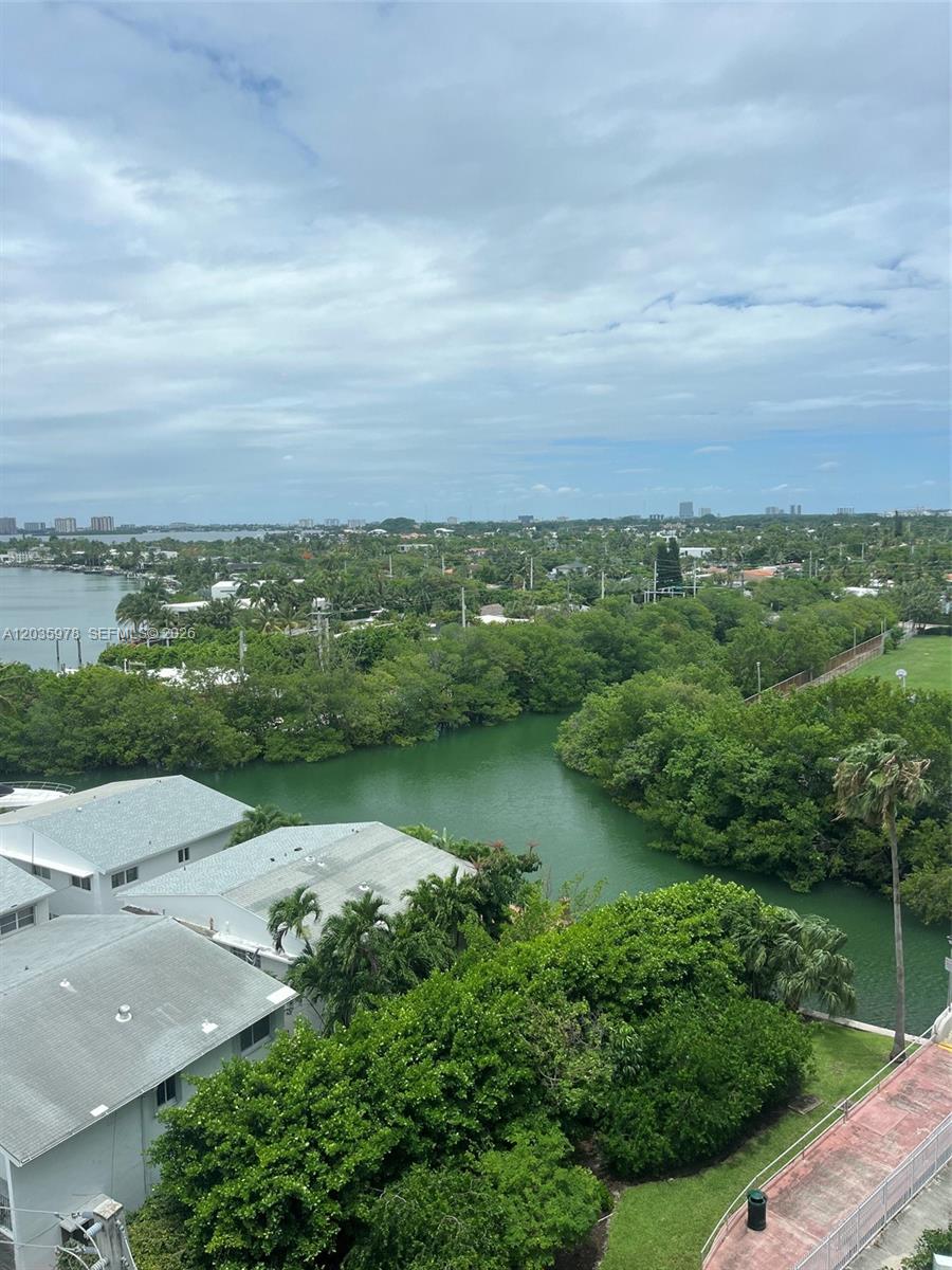 An elevated view of a waterway surrounded by lush trees and residential buildings — 7441 Wayne Ave # 8B, Miami Beach FL 33141, MIAMI BEACH, FL