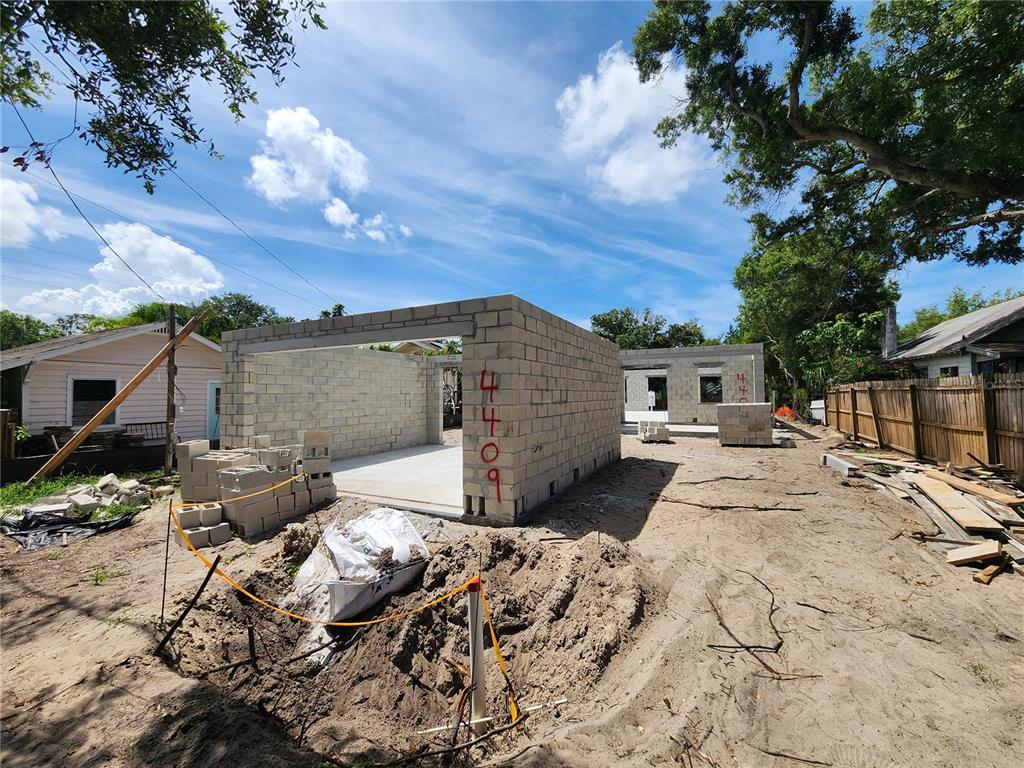A construction site shows the concrete block walls of a new building under a blue sky — 4409 2ND AVENUE N, ST PETERSBURG, FL