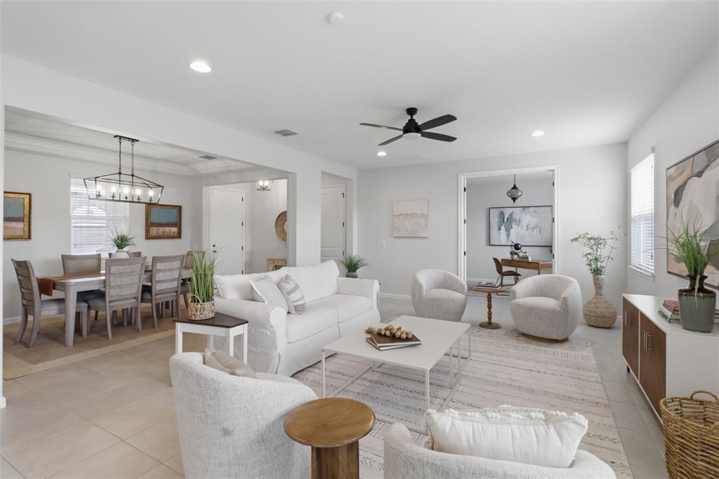 A bright, open-concept living and dining area features neutral furniture, tile flooring, and modern lighting — 1011 LEE SHORE STREET, VALRICO, FL