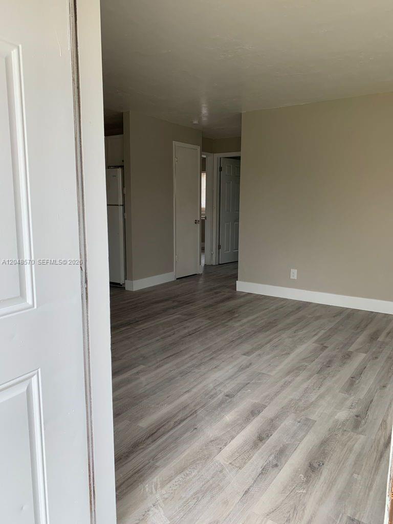 A view from a doorway into a living area with light wood-look flooring — 6317 SW 18th St # 1, Miramar FL 33023, MIRAMAR, FL