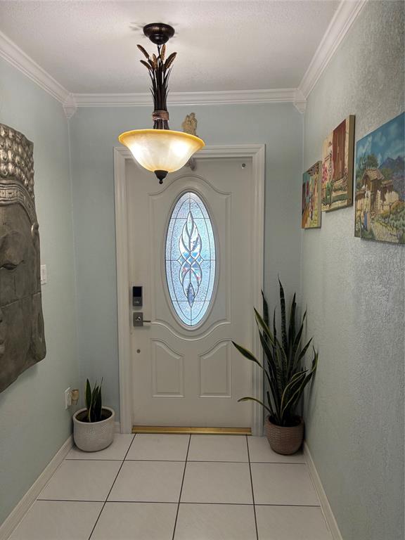 An entryway features a white door with an oval glass insert, tile flooring, and light-blue walls — 5450 GAMBIER COURT, ORLANDO, FL