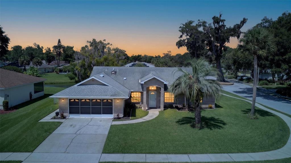 An aerial view of a single-story brick house with a screened garage and palm tree — 31 OLD SUNBEAM DRIVE, SOUTH DAYTONA, FL