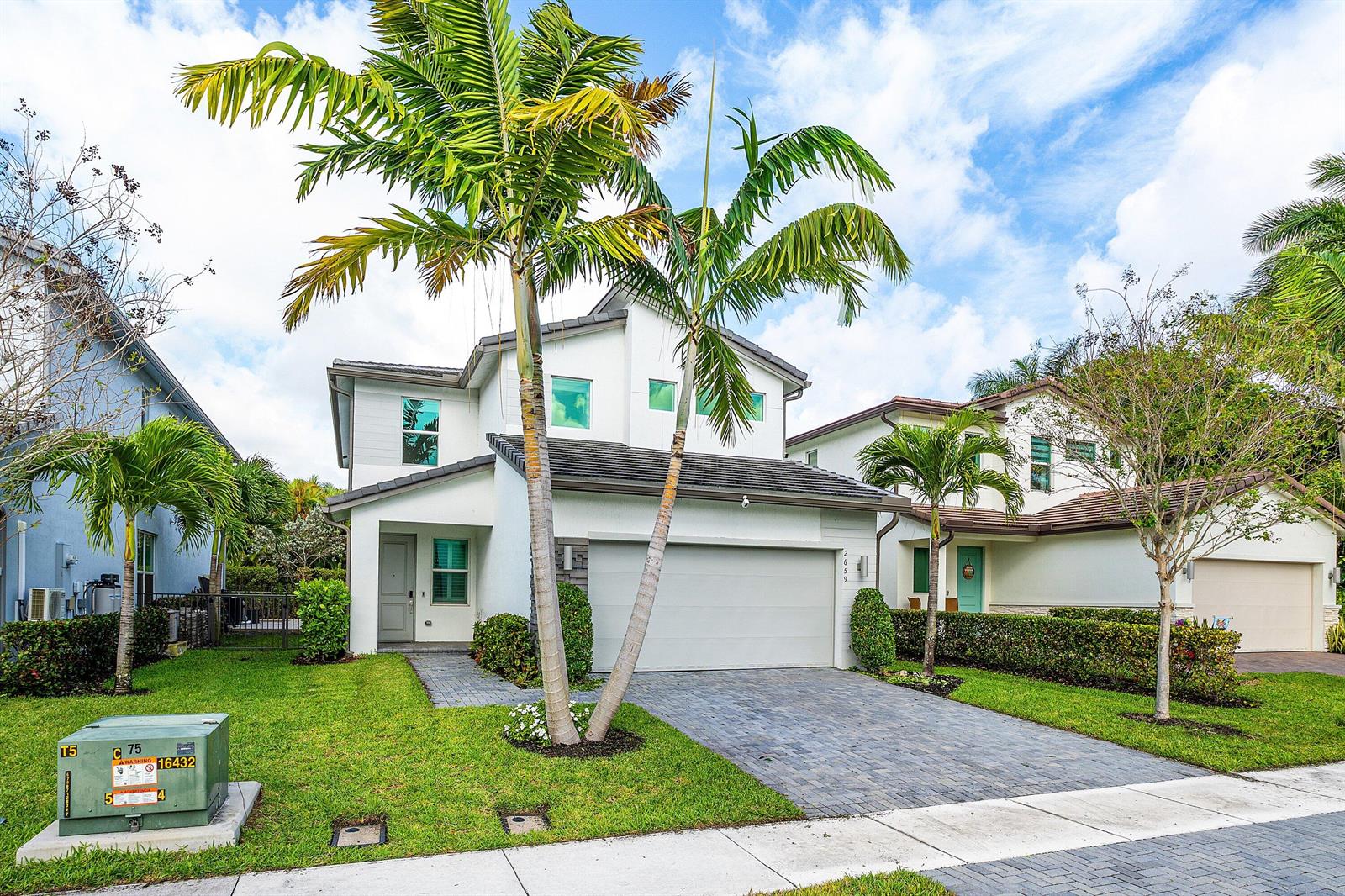 A two-story white house with a two-car garage and palm trees in the front yard — 2659 Country Lake Trail, Boynton Beach FL 33436, BOYNTON BEACH, FL