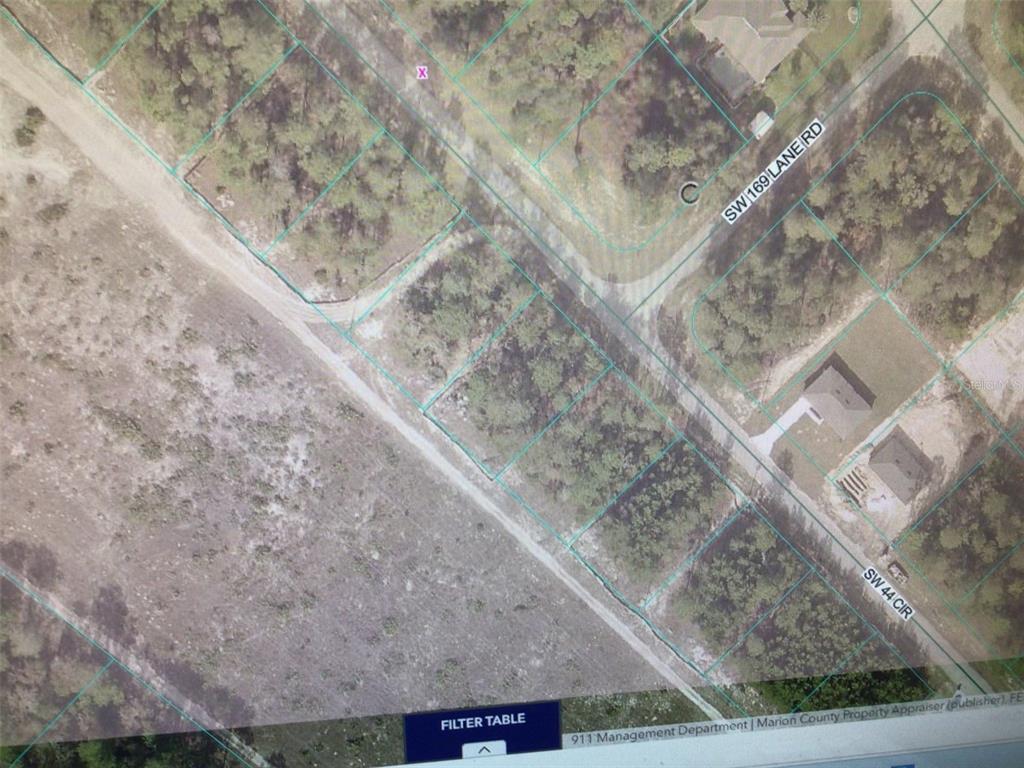 This is an aerial map view showing several wooded residential lots and nearby roads — 0 SW 44 CIRCLE, OCALA, FL