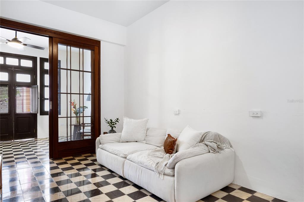 A white sofa sits against a wall on a black and white checkered floor — 360-362 FORTALEZA UNIT 7, SAN JUAN, PR