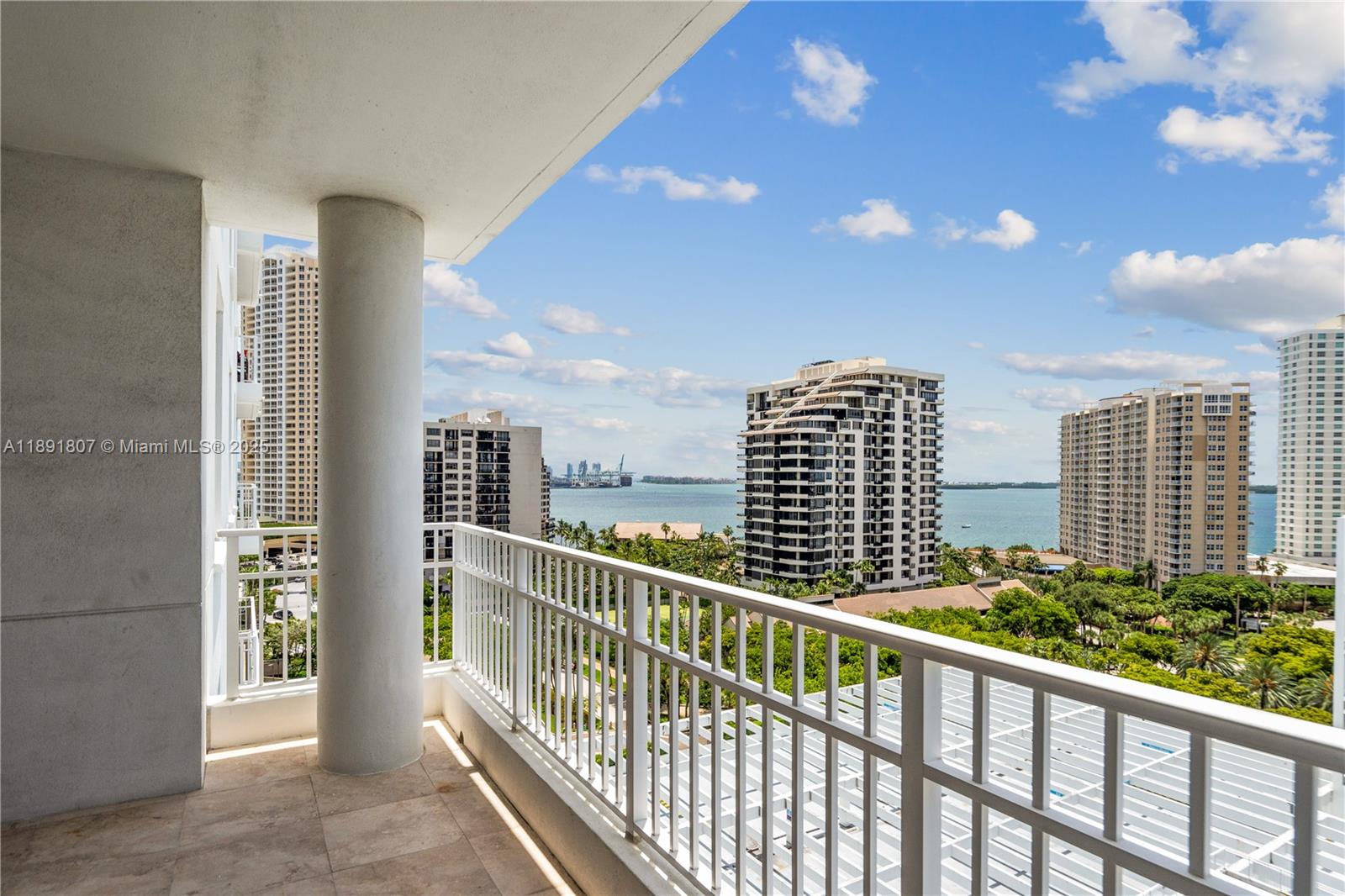 A balcony with a white railing overlooks a bay and several high-rise buildings — 701 Brickell Key Blvd # 1411, Miami FL 33131, MIAMI, FL