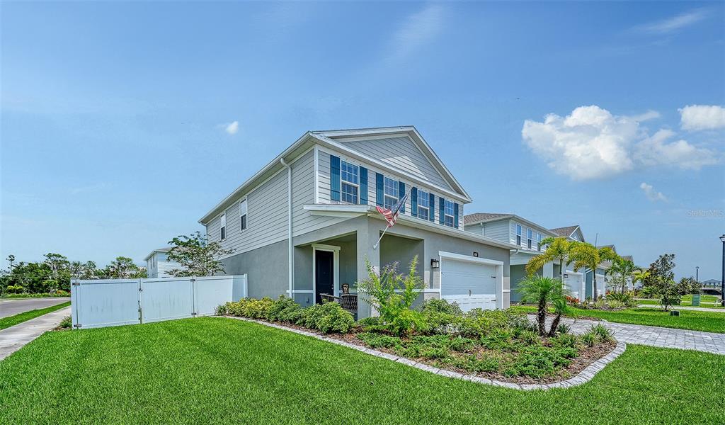A two-story suburban house with light gray siding, a white garage, and a white fence — 4507 ARDEN WAY, BRADENTON, FL