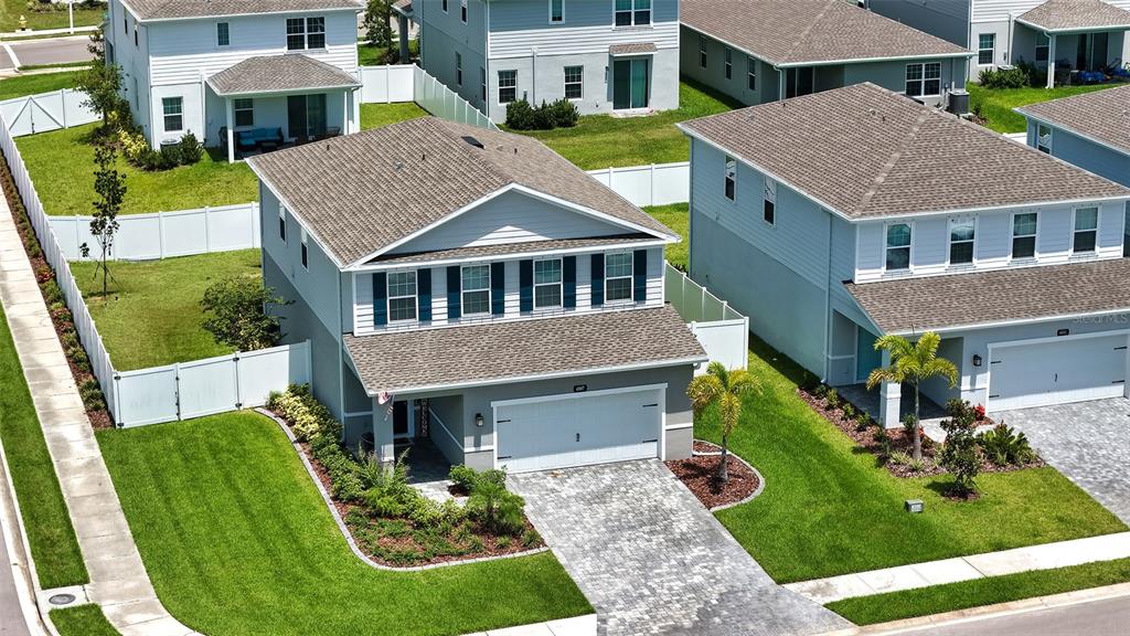 An aerial view of a two-story suburban house with a paved driveway and white fencing — 4507 ARDEN WAY, BRADENTON, FL