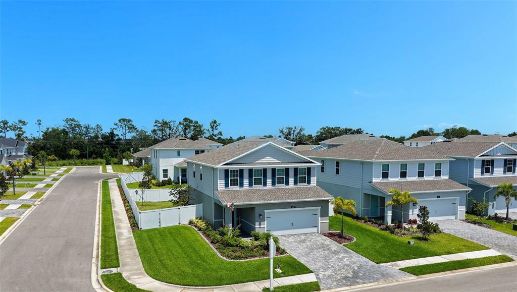 An aerial view shows a two-story suburban house with a paved driveway and green lawn — 4507 ARDEN WAY, BRADENTON, FL