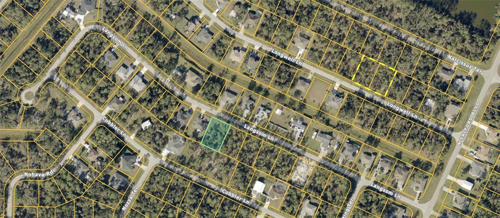 This is an aerial map showing a vacant residential lot highlighted in green — LANGSOM LANE, NORTH PORT, FL