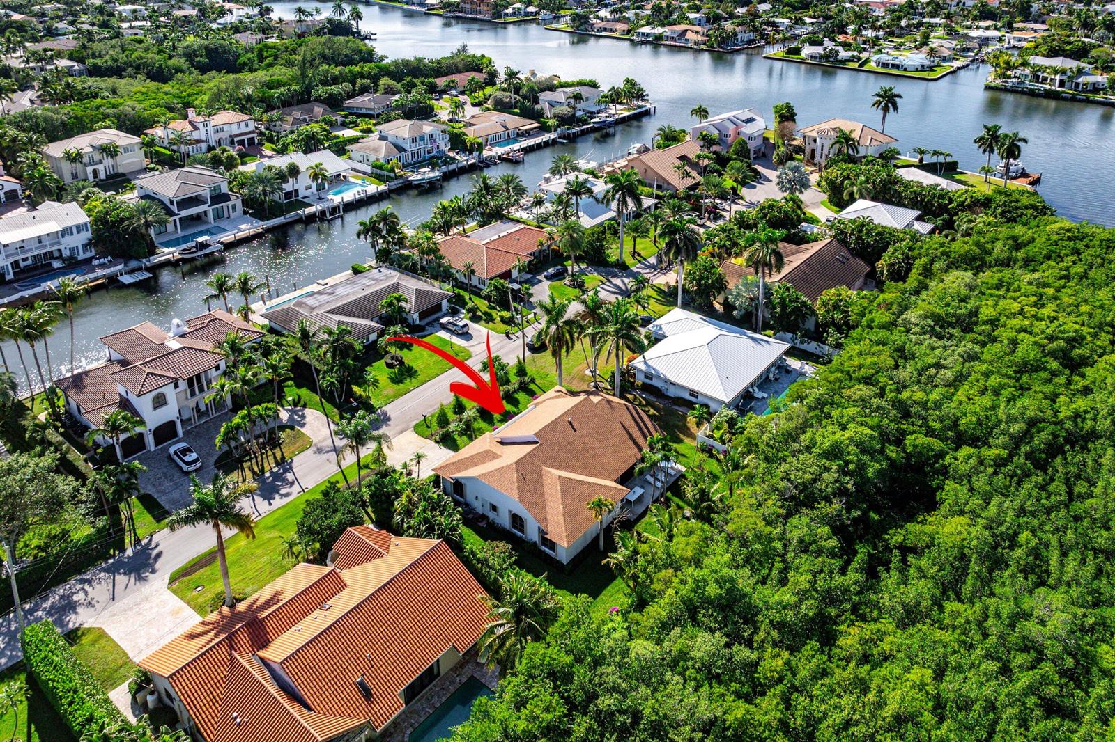 An aerial view of a residential neighborhood featuring houses with brown roofs and swimming pools — 48 Harbour Drive N, Boynton Beach FL 33435, BOYNTON BEACH, FL