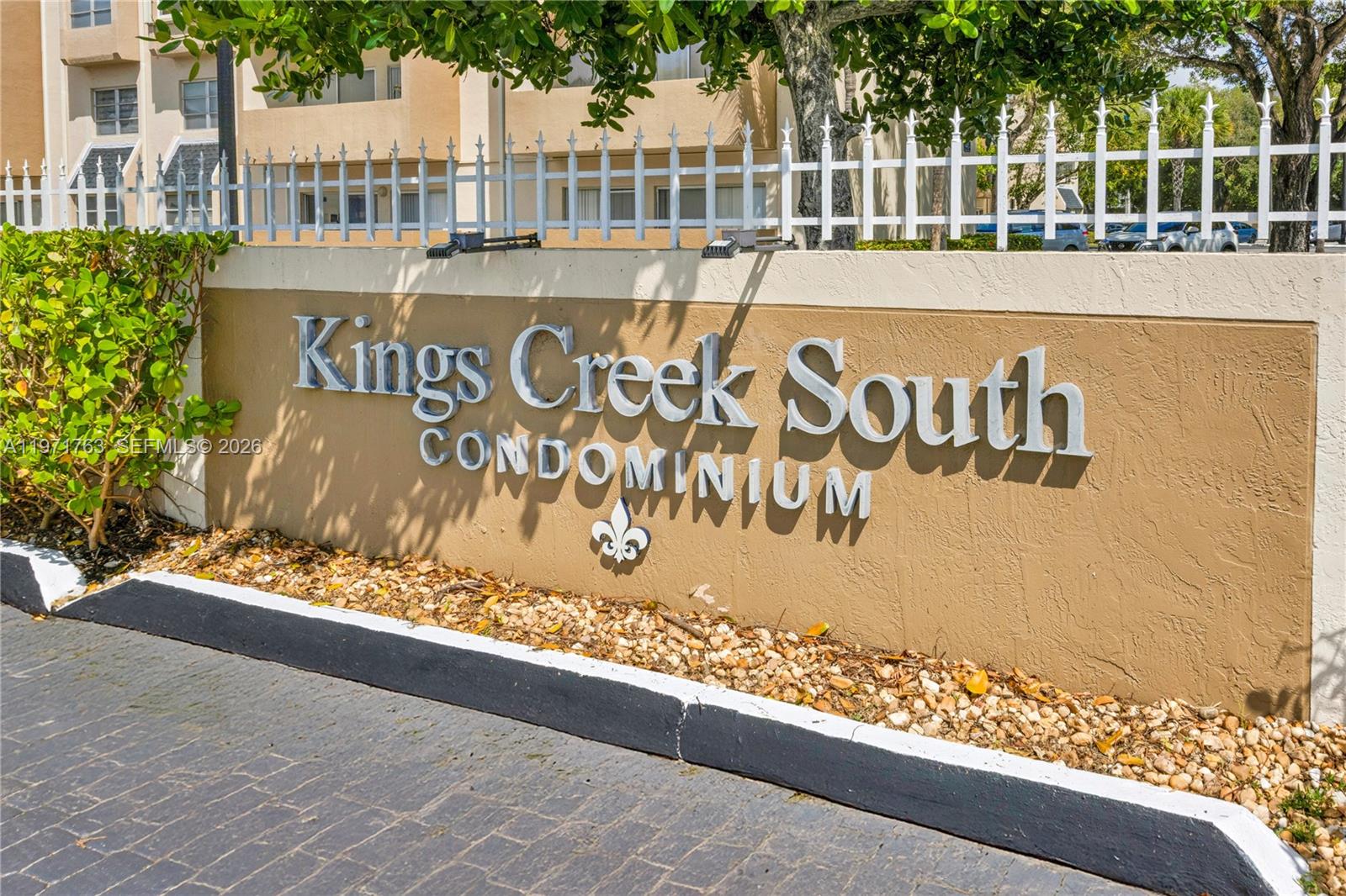 A sign for Kings Creek South Condominium stands in front of a multi-story residential building — 7785 SW 86th St # 414, Miami FL 33143, MIAMI, FL