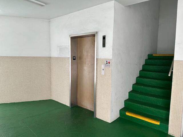 An elevator and a green staircase with yellow safety strips are in a tiled room — 1380 NW 43 Terrace # 306, Lauderhill FL 33313, LAUDERHILL, FL