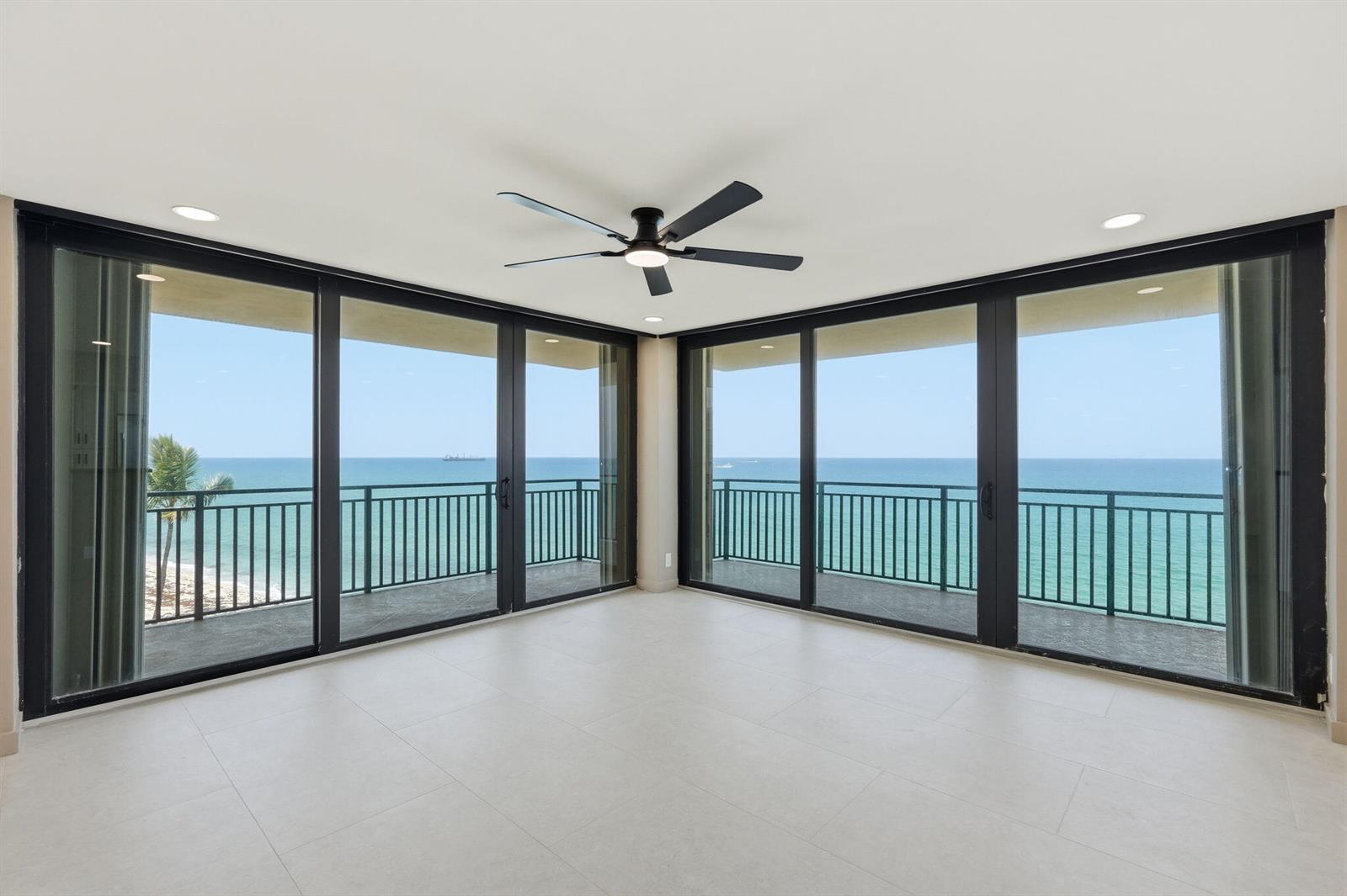 An empty room features large sliding glass doors overlooking the ocean and a ceiling fan — 5460 N Ocean Drive # 6a, Riviera Beach FL 33404, RIVIERA BEACH, FL