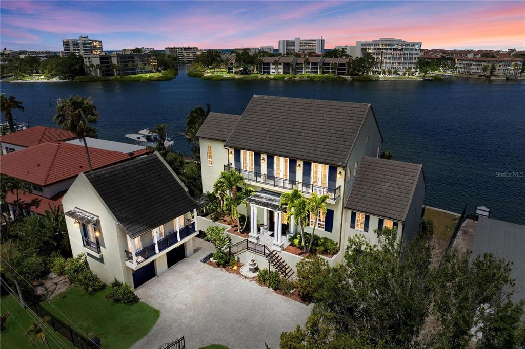 An aerial view shows a multi-story house with a detached garage and waterfront access — 6438 HOLLYWOOD BOULEVARD, SARASOTA, FL