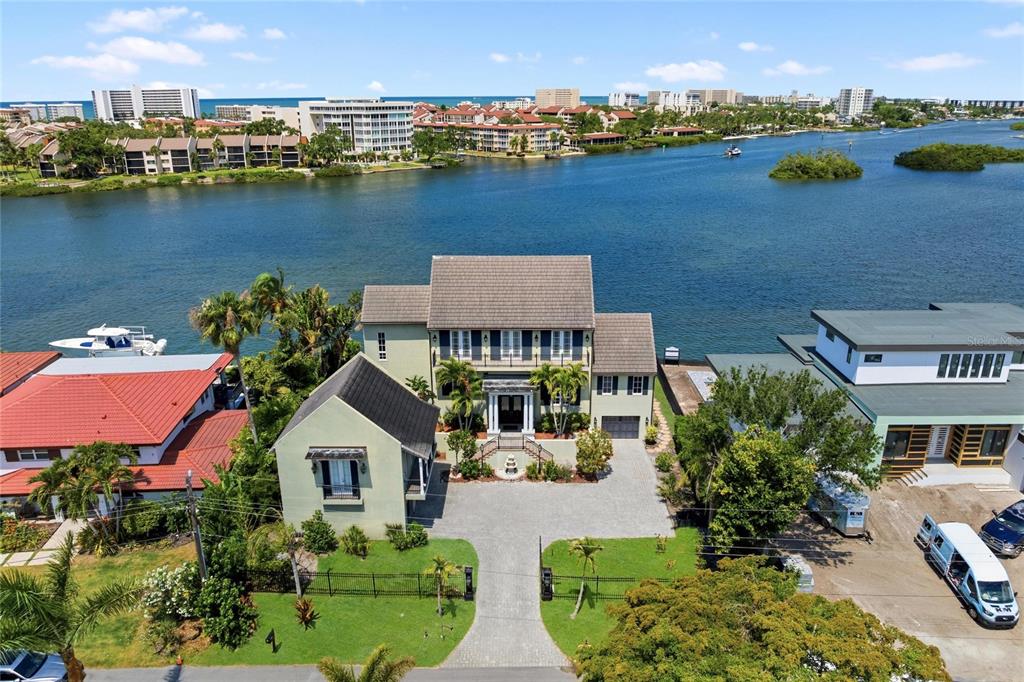 An aerial view shows a multi-story house with a paved driveway facing a large bay — 6438 HOLLYWOOD BOULEVARD, SARASOTA, FL