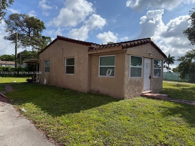A single-story stucco house with a tiled roof sits on a grassy lot — 6013 SW 34th St, Miramar FL 33023, MIRAMAR, FL