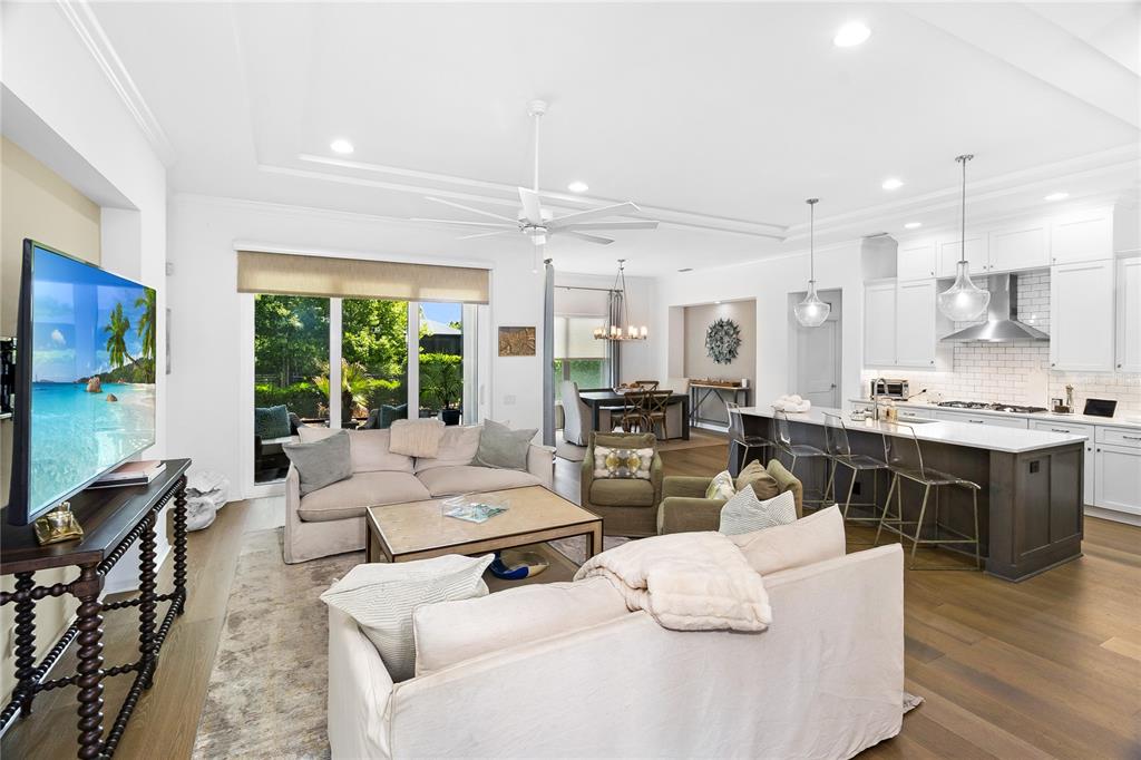 An entryway with a decorative mirror and console table leads into a bright, open-concept living area — 3363 SW 115TH TERRACE, GAINESVILLE, FL