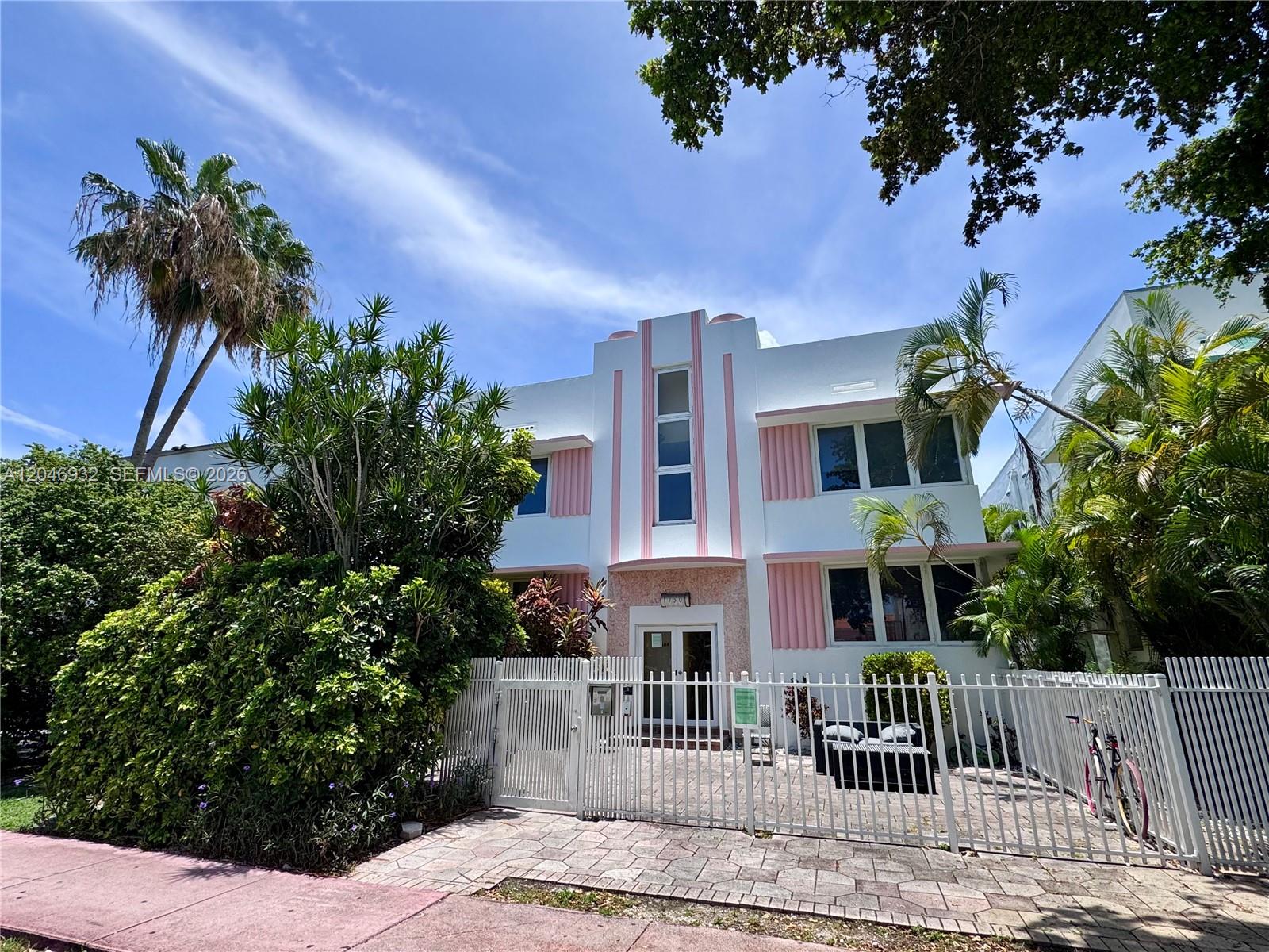 A two-story Art Deco building with pink accents stands behind a white metal fence — 750 Jefferson Ave # 4, Miami Beach FL 33139, MIAMI BEACH, FL