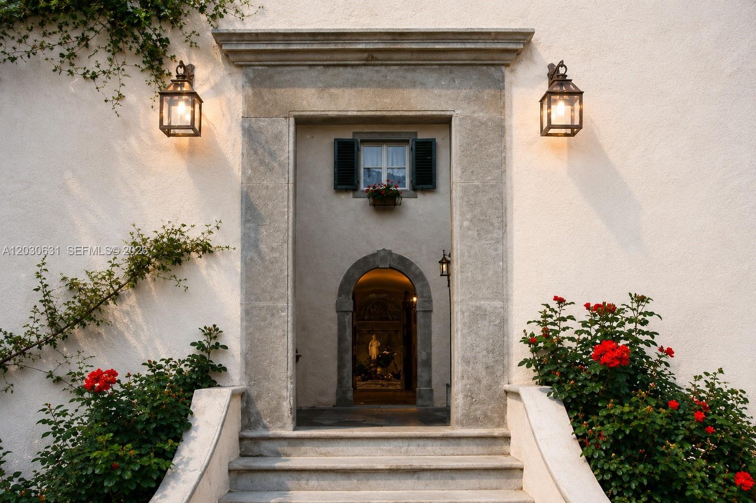 An arched stone doorway leads to an entryway with a statue and a small window — Tuscany Luxury Estate Florence Max Mlekus, FL
