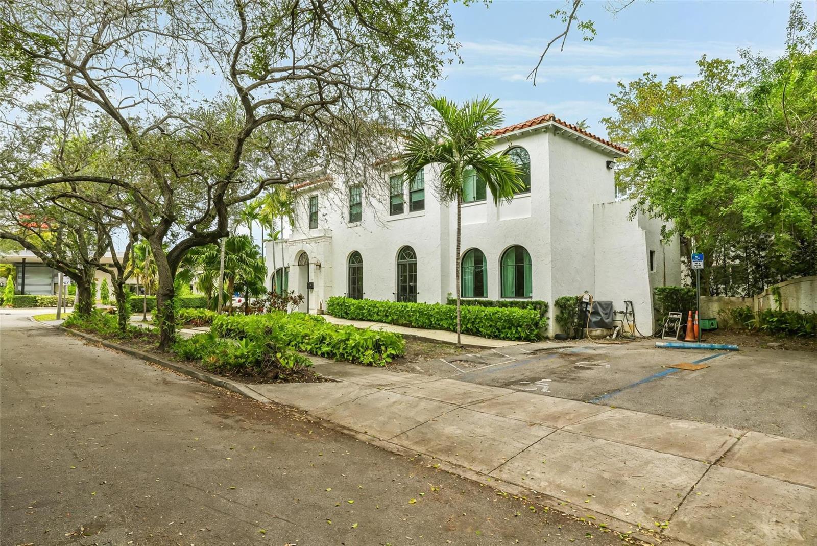 A two-story white stucco building with arched windows and a red tile roof — 445 NE 56, Miami FL 33137, MIAMI, FL