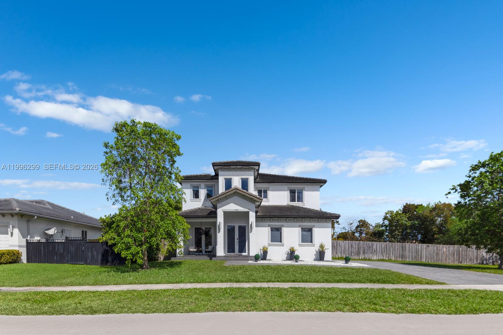 A two-story white house with a dark tiled roof and a central entryway — 19781 SW 84th Ct, Cutler Bay FL 33189, CUTLER BAY, FL