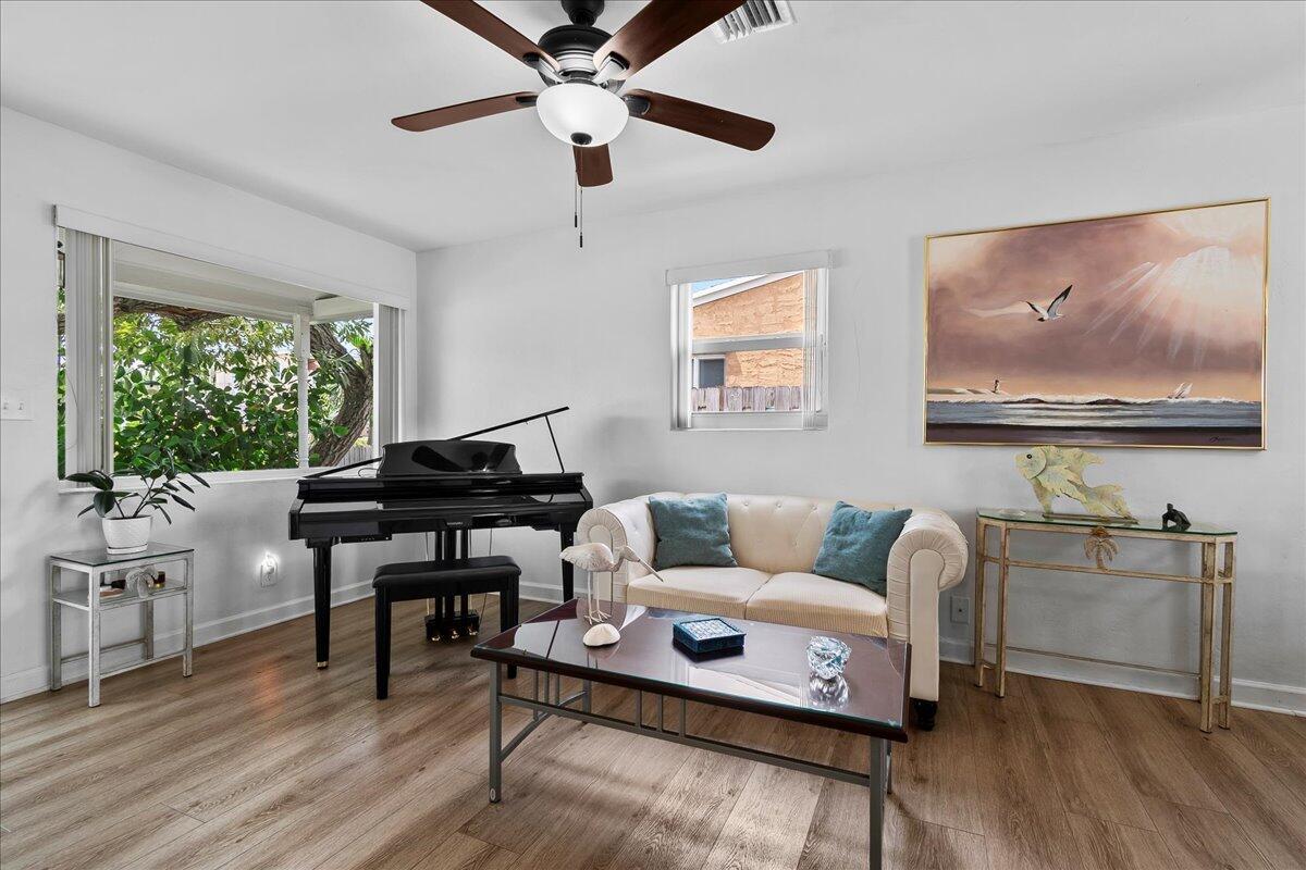 A living room features a black piano, a cream sofa, and a glass coffee table — 727 Bunker Road, West Palm Beach FL 33405, WEST PALM BEACH, FL