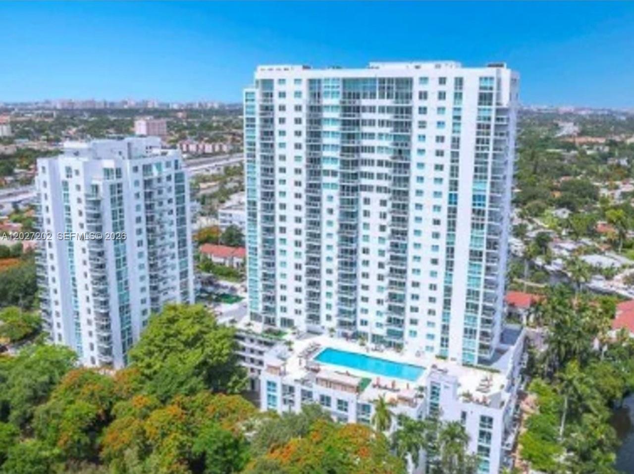 An aerial view shows two tall residential buildings with a swimming pool on the lower deck — 1861 NW S River Dr # 2008, Miami FL 33125, MIAMI, FL