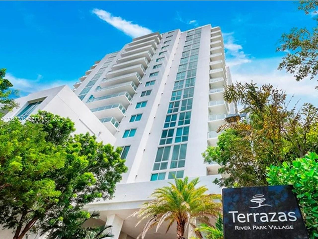 A low-angle view of the white exterior of the Terrazas River Park Village high-rise building — 1861 NW S River Dr # 2008, Miami FL 33125, MIAMI, FL