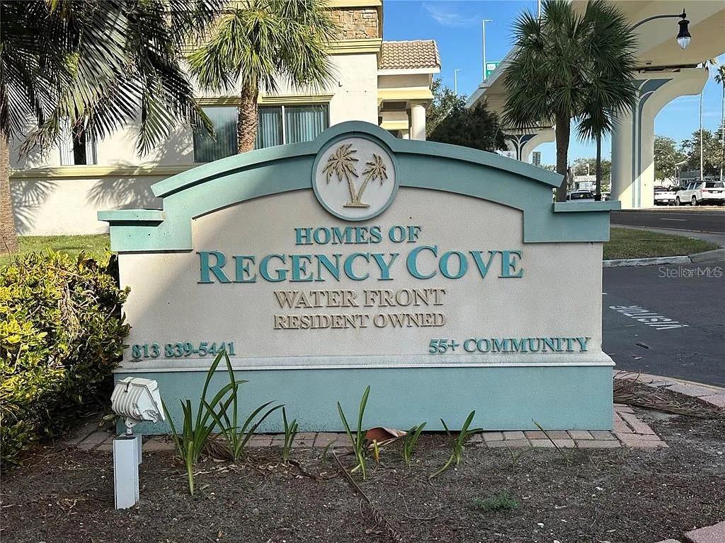 A sign for the Homes of Regency Cove 55+ community stands in front of a building — 4851 W GANDY BOULEVARD UNIT B5L37, TAMPA, FL