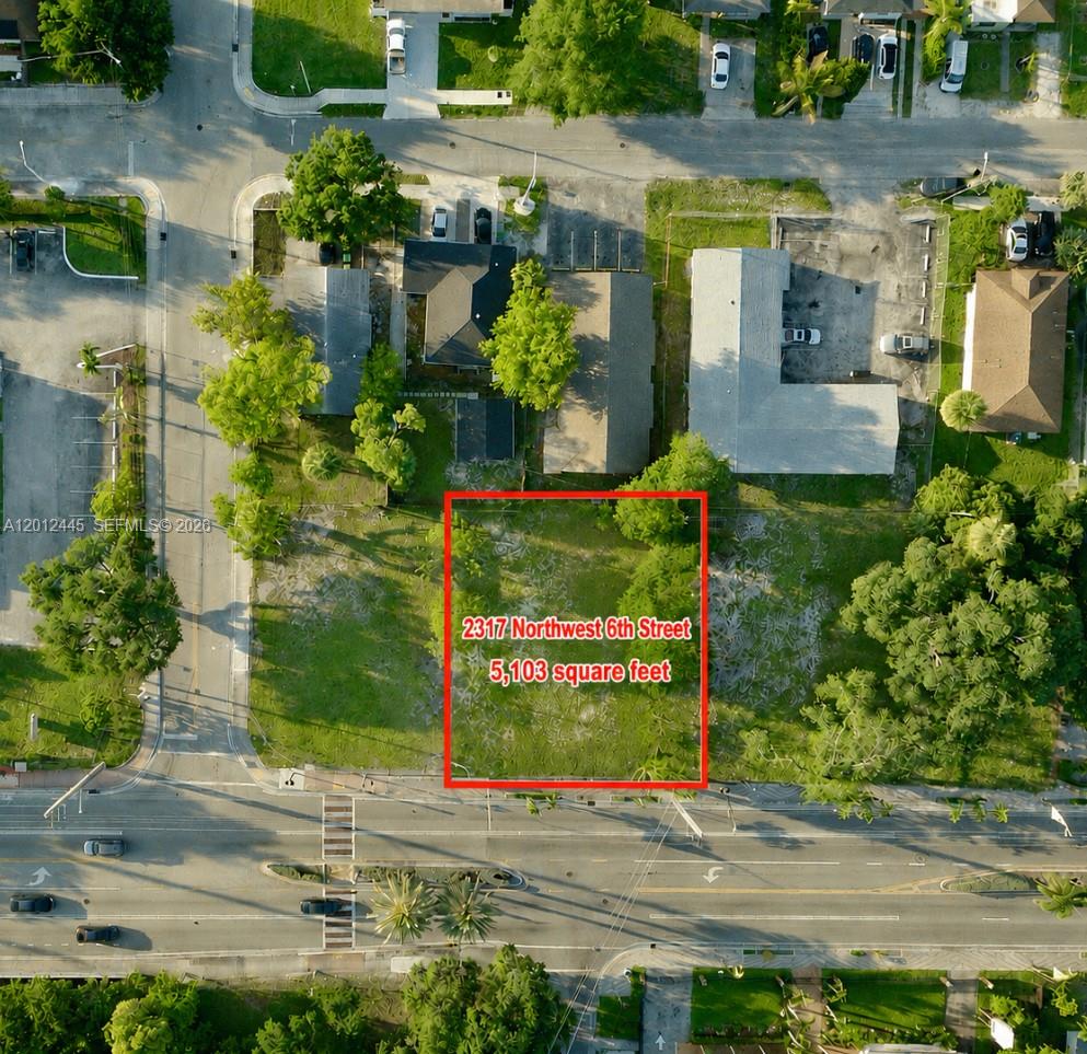 An aerial view shows a vacant rectangular lot outlined in red next to existing buildings — FORT LAUDERDALE, FL
